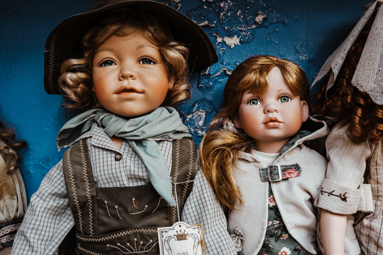 Services Charming vintage porcelain dolls dressed in rustic attire, perfect for collectors.